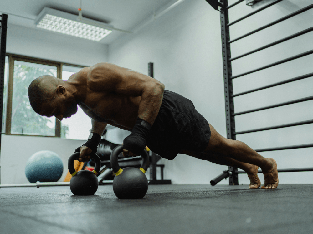 Client performing kettlebell push-ups during a live online personal training session with Body360 Fit Los Angeles